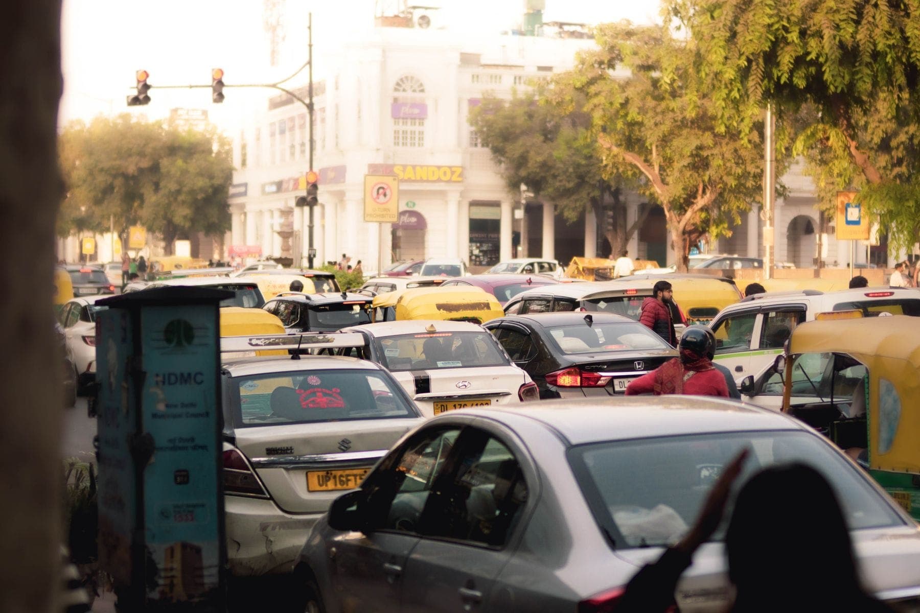 Dense Delhi traffic with autos, cars and two-wheelers